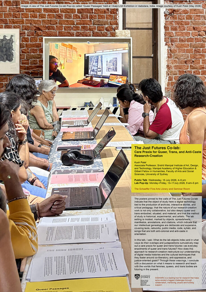 A poster with a view of the Just Futures Co-lab Pop-Up at Vikalp Art Exhibition in Vadodara (May 2026), comprising a long tabletop display of computers on the one side and a citational runner in print on the other side. People seated on either side of this table arrangement are viewing a video at the end on a wall-hung TV monitor.